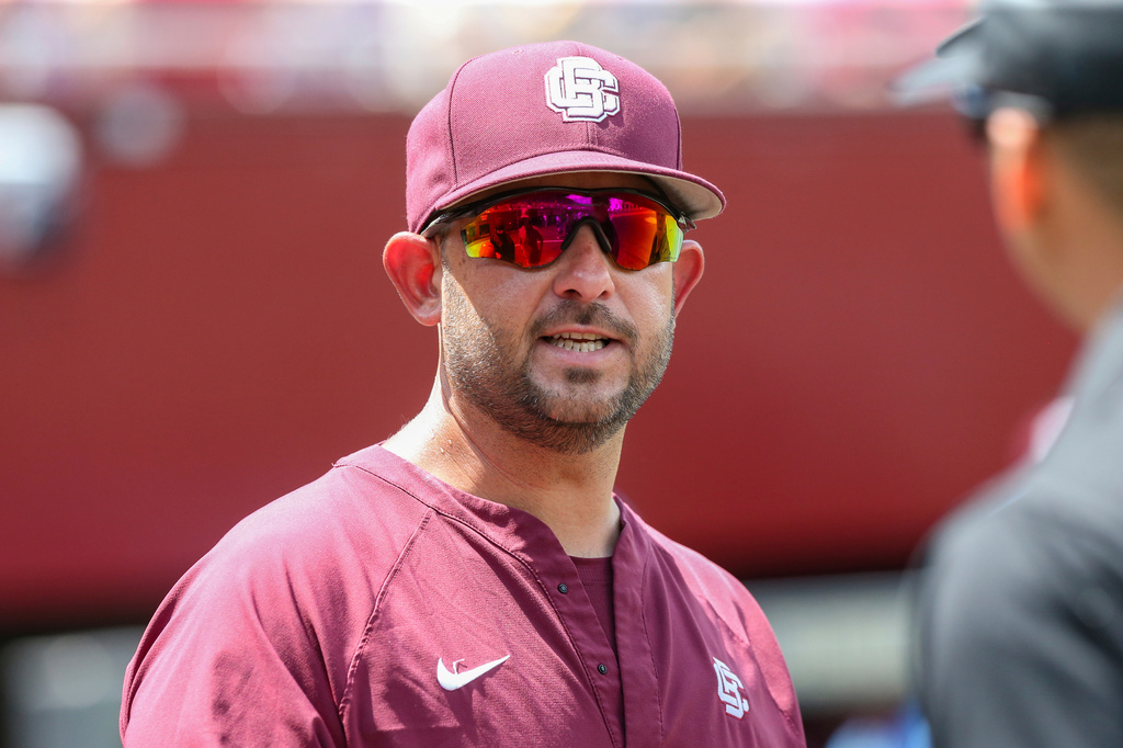 FILE - Bethune Cookman head coach Jonathan Hernandez meets with officials before an NCAA regional tournament baseball game against Florida State, May 30, 2025, in Tallahassee, Fla. (AP Photo/Gary McCullough, File)