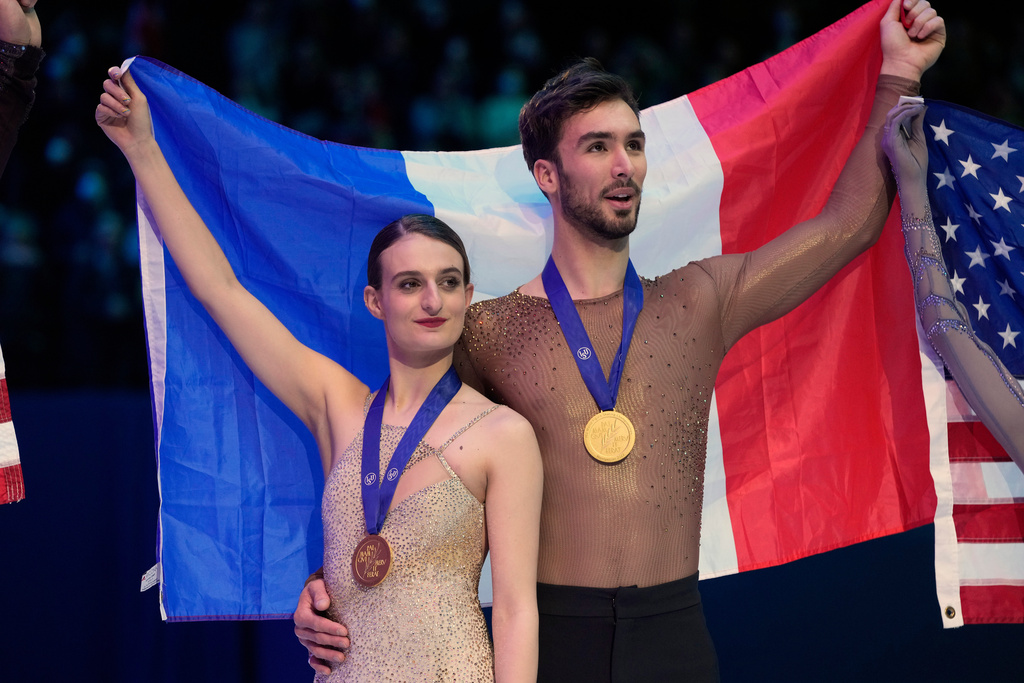 FILE - Gabriella Papadakis and Guillaume Cizeron of France celebrate their gold medal during the Ice Dance victory ceremony at the Figure Skating World Championships in Montpellier, south of France, Saturday, March 26, 2022. (AP Photo/Francisco Seco, file)