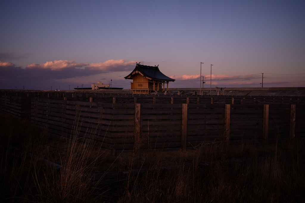 Kusano shrine, destroyed by the 2011 tsunami and later rebuilt, stands in fields in Namie, Fukushima Prefecture, Thursday, Feb. 12, 2026. (AP Photo/Louise Delmotte)