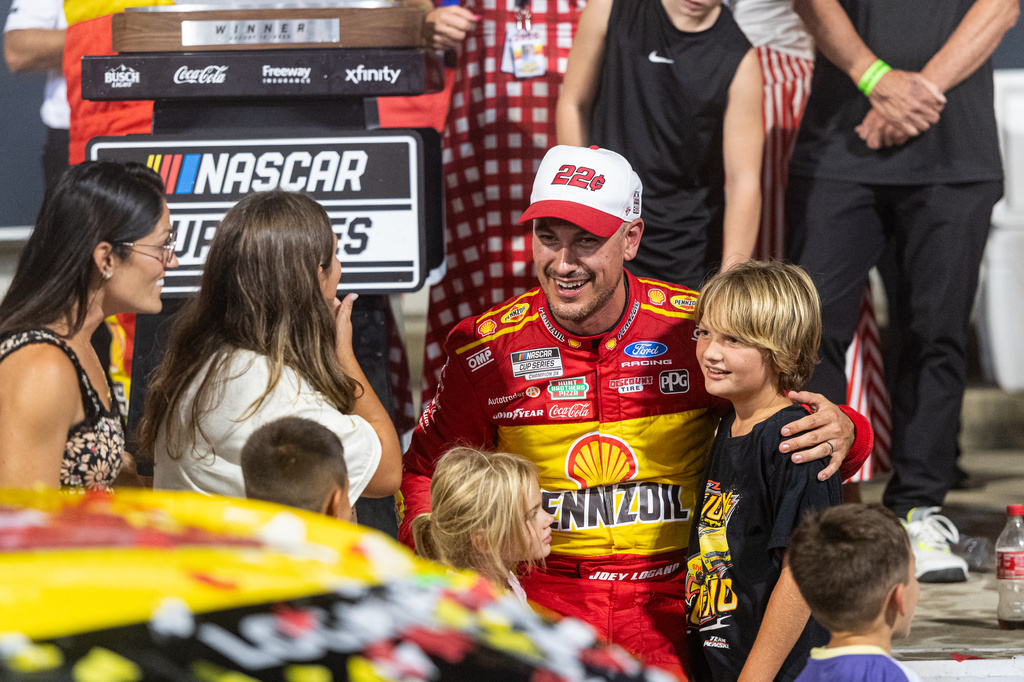 Team Penske driver Joey Logano (22) celebrates with family in victory lane after winning the Cook Out 400 at Richmond Raceway, Saturday, Aug. 15, 2026, in Richmond Va. (AP Photo/Robert Simmons)
