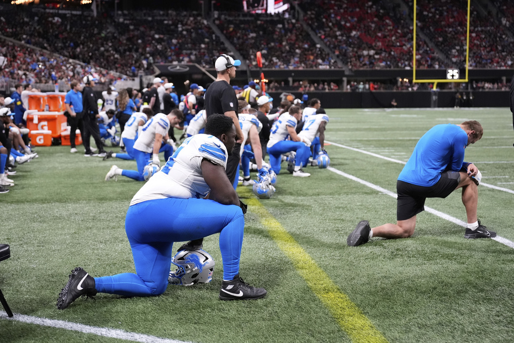 Detroit Lions players take a knee after safety Morice Norris was injured against the Atlanta Falcons during the second half of an NFL preseason football game Friday, Aug. 8, 2025, in Atlanta. (AP Photo/Brynn Anderson)