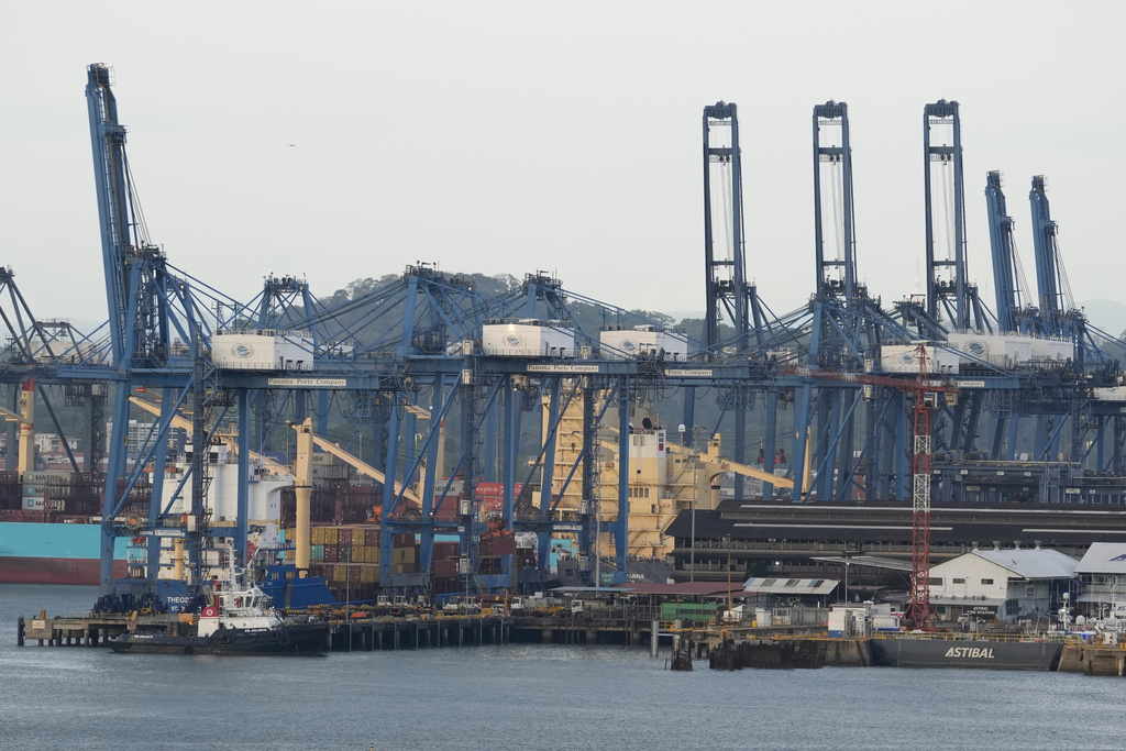 FILE -Cranes load a cargo ship at the Panama Canal's Port of Balboa, managed by CK Hutchison Holdings, in Panama City, March 13, 2025. (AP Photo/Matias Delacroix, File)
