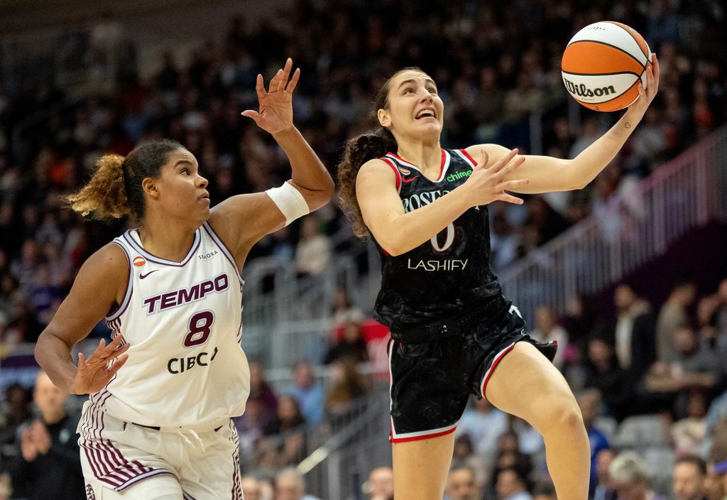 Portland Fire guard Carle Leite (0) drives to the basket past Toronto Tempo forward Nyara Sabally (8) during first-half WNBA basketball game action in Toronto, Saturday May 23, 2026. (Frank Gunn/The Canadian Press via AP)