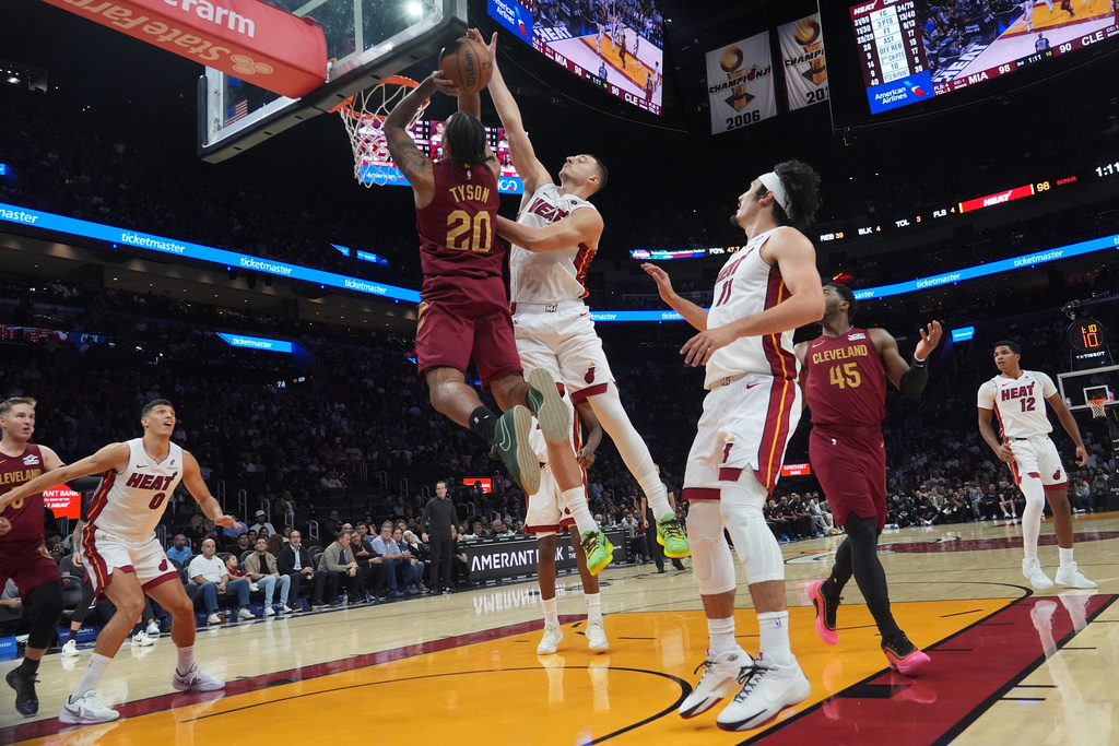 Cleveland Cavaliers guard Jaylon Tyson (20) drives to the basket as Miami Heat forward Nikola Jovic (5) defends during the second half of an NBA basketball game Monday, Nov. 10, 2025, in Miami. (AP Photo/Marta Lavandier)