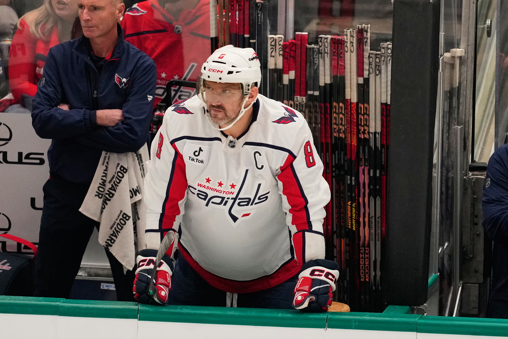 Washington Capitals left wing Alex Ovechkin watches play from the bench in the first period of an NHL hockey game against the Dallas Stars Tuesday, Oct. 28, 2025, in Dallas. (AP Photo/Tony Gutierrez)