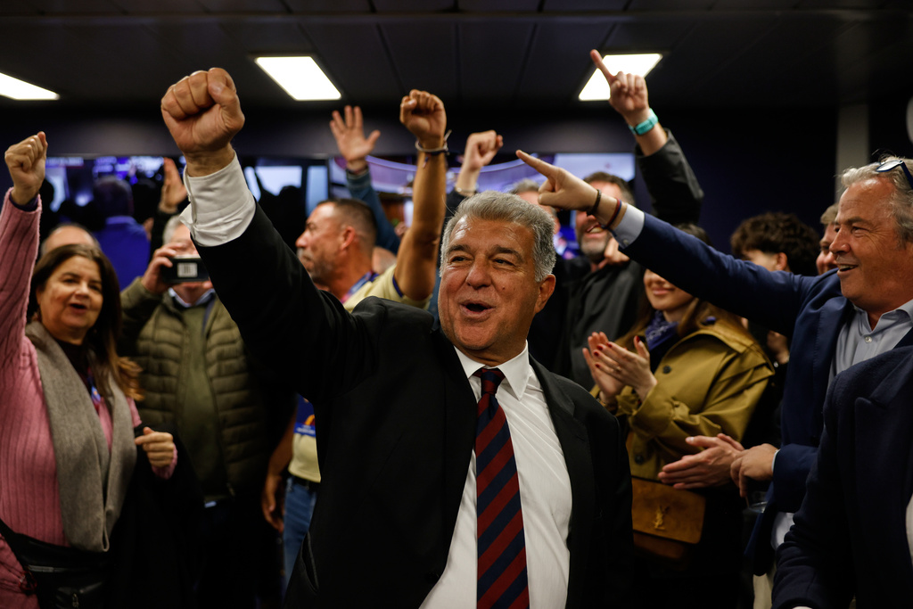 Candidate, Joan Laporta, center, reacts during early voting projections for the election to be president of FC Barcelona in Barcelona, Spain, Sunday, March 15, 2026. (AP Photo/Joan Monfort)