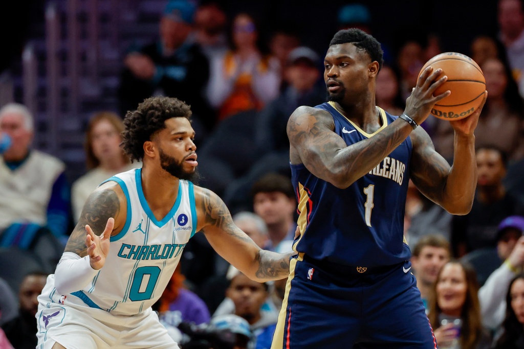 New Orleans Pelicans forward Zion Williamson (1) looks to pass the ball against Charlotte Hornets forward Miles Bridges (0) during the first half of an NBA basketball game in Charlotte, N.C., Monday, Feb. 2, 2026. (AP Photo/Nell Redmond)