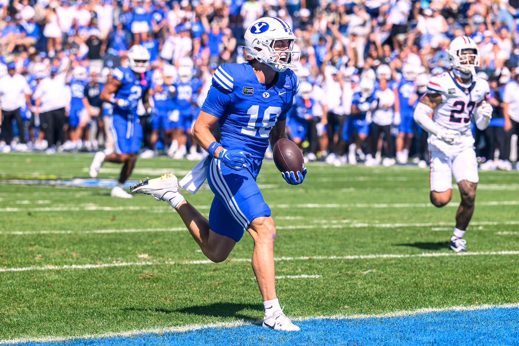 BYU wide receiver Reggie Frischknecht (18) runs the ball in for a touchdown during the first half an NCAA college football game against Arizona, Saturday, Sept. 12, 2026, in Provo, Utah. (AP Photo/Tyler Tate)