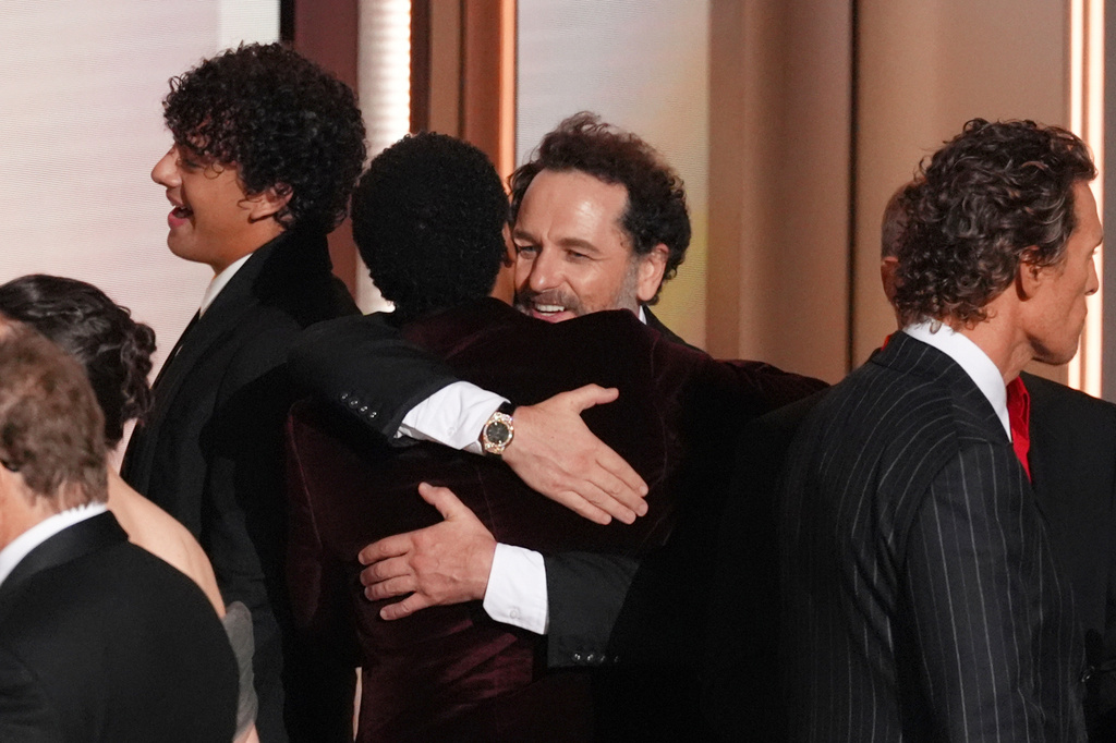 Matthew Rhys, center, and the team from "Widow's Bay" celebrates winning the award for outstanding comedy series during the 78th Emmy Awards on Monday, Sept. 14, 2026, at the Peacock Theater in Los Angeles. Matthew McConaughey, second right, and Mariska Hargitay appear right of stage. (AP Photo/Chris Pizzello)