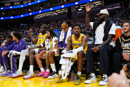 Los Angeles Lakers guard Bronny James Jr. (9) listens to his father and teammate Lebron James, second from right, as they sit on the bench during the first half of an NBA basketball preseason game against the Golden State Warriors, Sunday, Oct. 5, 2025, in San Francisco. (AP Photo/Godofredo A. Vásquez) Los Angeles Lakers guard Bronny James Jr. (9) listens to his father and teammate Lebron James, second from right, as they sit on the bench during the first half of an NBA basketball preseason game against the Golden State Warriors, Sunday, Oct. 5, 2025, in San Francisco. (AP Photo/Godofredo A. Vásquez)
