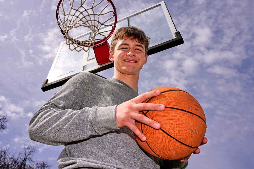 Otto Schellhamer, an eighth-grader who has the only perfect bracket after the opening weekend of the men’s and women’s NCAA college basketball tournaments, poses in his backyard in Plum Borough, Pa., Wednesday, March 25, 2026. (AP Photo/Gene J. Puskar)