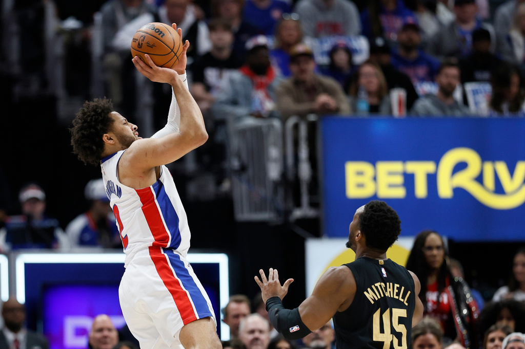 Detroit Pistons guard Cade Cunningham takes a shot against Cleveland Cavaliers guard Donovan Mitchell (45) during the first half in Game 2 of a second-round NBA playoffs basketball series, Thursday, May 7, 2026, in Detroit. (AP Photo/Duane Burleson)