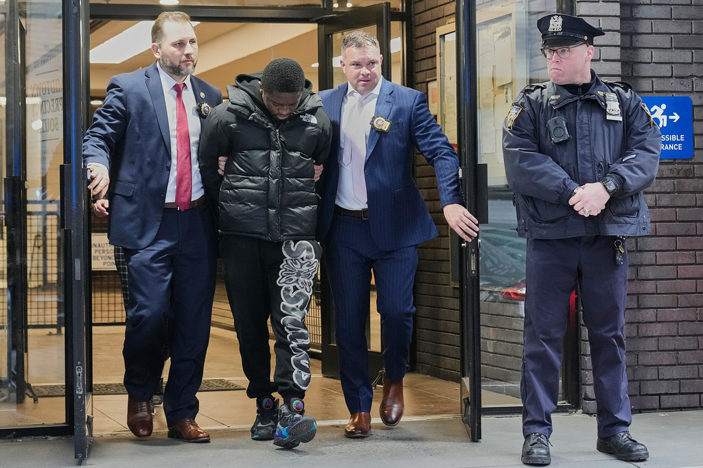 Frederick Green, 20, of The Bronx borough of New York, charged with attempted murder in the shooting of New York Jets' player Kris Boyd, is escorted from the Midtown South Police Precinct, in New York, Tuesday, Dec. 9, 2025. (AP Photo/Richard Drew)