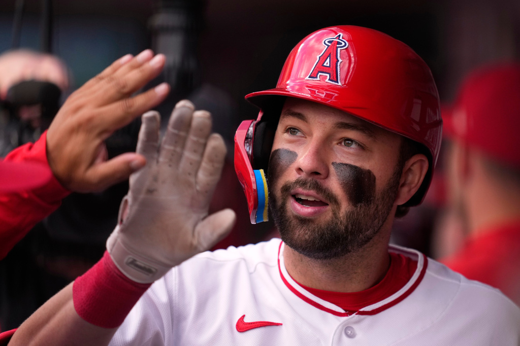 Los Angeles Angels' Nolan Schanuel is congratulated by teammates in the dugout after hitting a two-run home run during the first inning of a baseball game against the Baltimore Orioles, Tuesday, June 23, 2026, in Anaheim, Calif. (AP Photo/Mark J. Terrill)