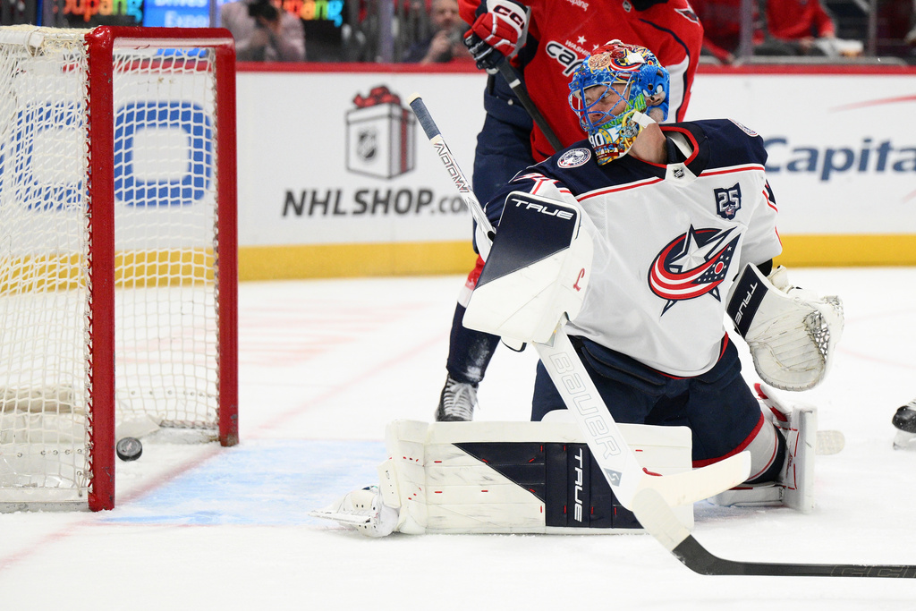 Columbus Blue Jackets goaltender Elvis Merzlikins looks back at a puck shot by Washington Capitals defenseman Jakob Chychrun for a goal during the first period of an NHL hockey game, Monday, Nov. 24, 2025, in Washington. (AP Photo/Nick Wass)