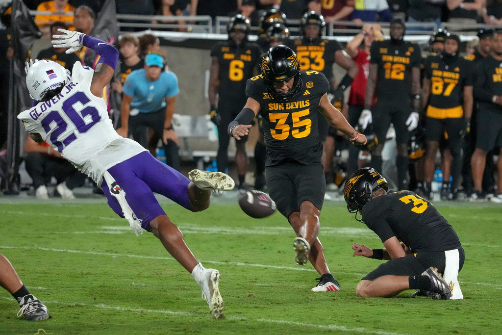 Arizona State Sun Devils place kicker Jesus Gomez (35) kicks a game winning field goal against a diving TCU Horned Frogs cornerback Vernon Glover (26) during the second half of an NCAA college football game Friday, Sept. 26, 2025, in Tempe, Ariz. (AP Photo/Darryl Webb)
