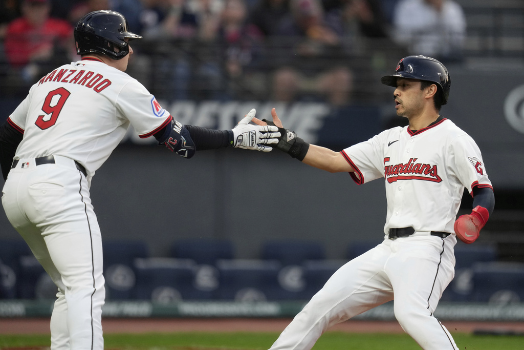 Cleveland Guardians' Steven Kwan, right, is congratulated by Cleveland Guardians' Kyle Manzardo (9) after scoring in the third inning of a baseball game against the Kansas City Royals in Cleveland, Monday, Sept. 8, 2025. (AP Photo/Sue Ogrocki)