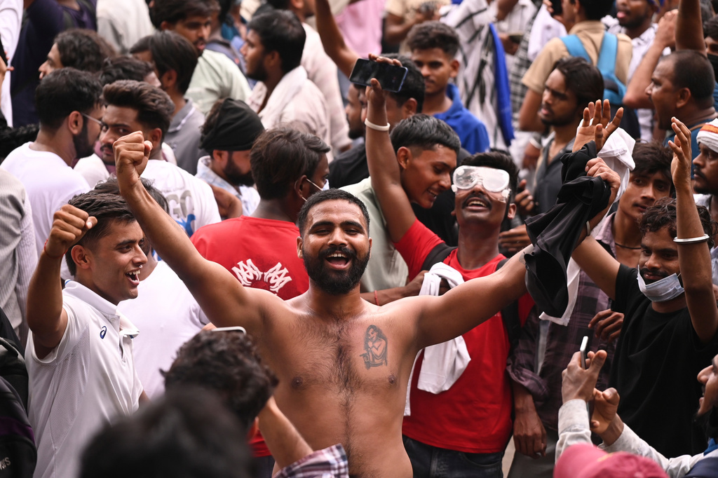 Protesters react after India's Education Minister Dharmendra Pradhan resigned following nationwide protests as part of the Cockroach Janta Party's protest movement in New Delhi, India, Saturday, July 25, 2026. (AP Photo/Vipin)