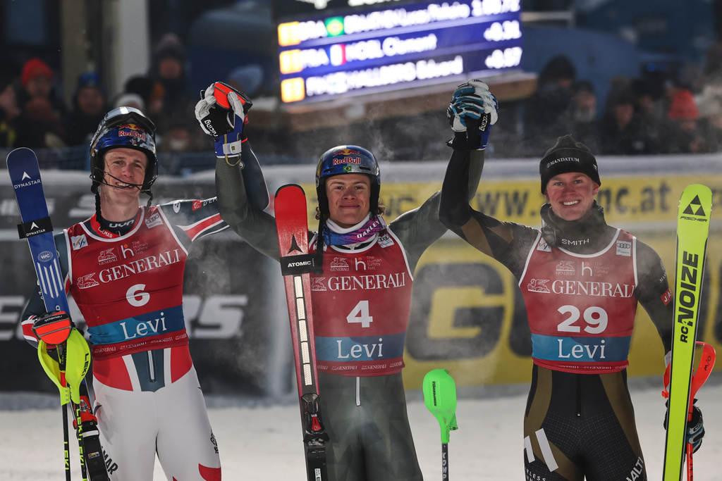Brazil's Lucas Pinheiro Braathen, center, winner of an alpine ski, men's World Cup slalom, poses with second placed France's Clement Noel, left, and third placed Finland's Eduard Hallberg in Levi, Finland, Sunday, Nov. 16, 2025. (AP Photo/Marco Trovati)