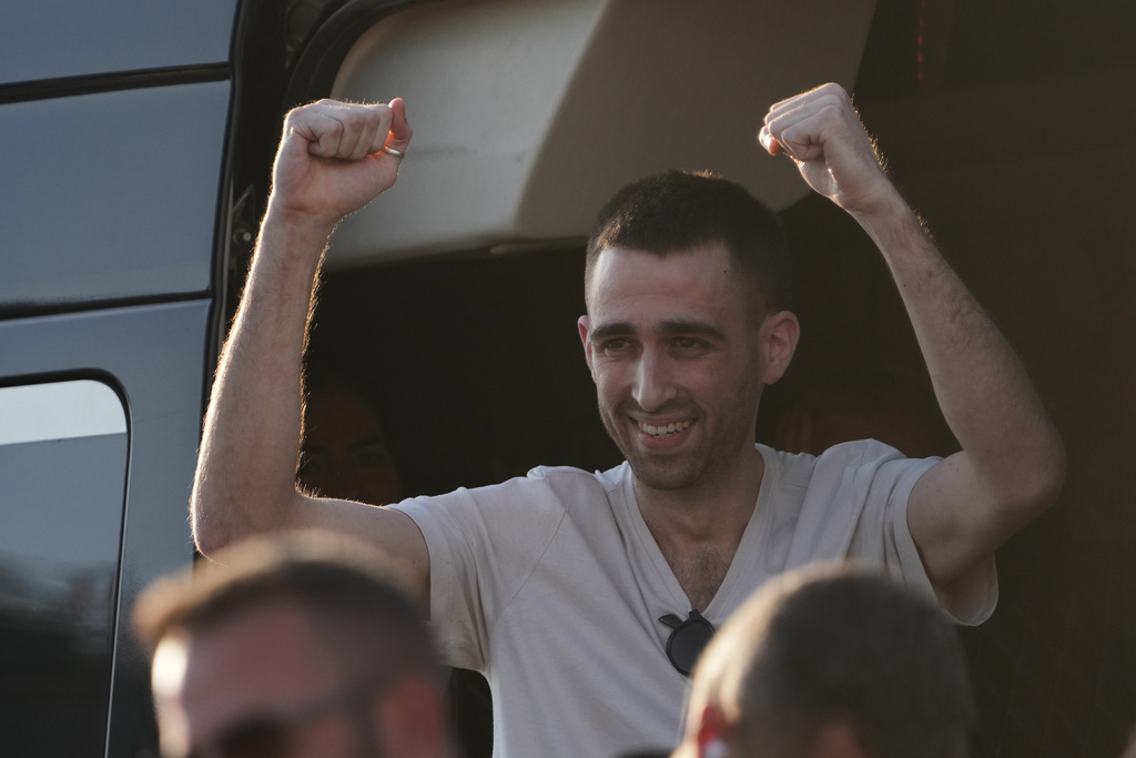 Freed Israeli hostage Avinatan Or gestures from a van as he arrives at Beilinson hospital in Petah Tikva, Israel, after he was released from Hamas captivity in the Gaza Stripl, Monday, Oct. 13, 2025. (AP Photo/Francisco Seco)