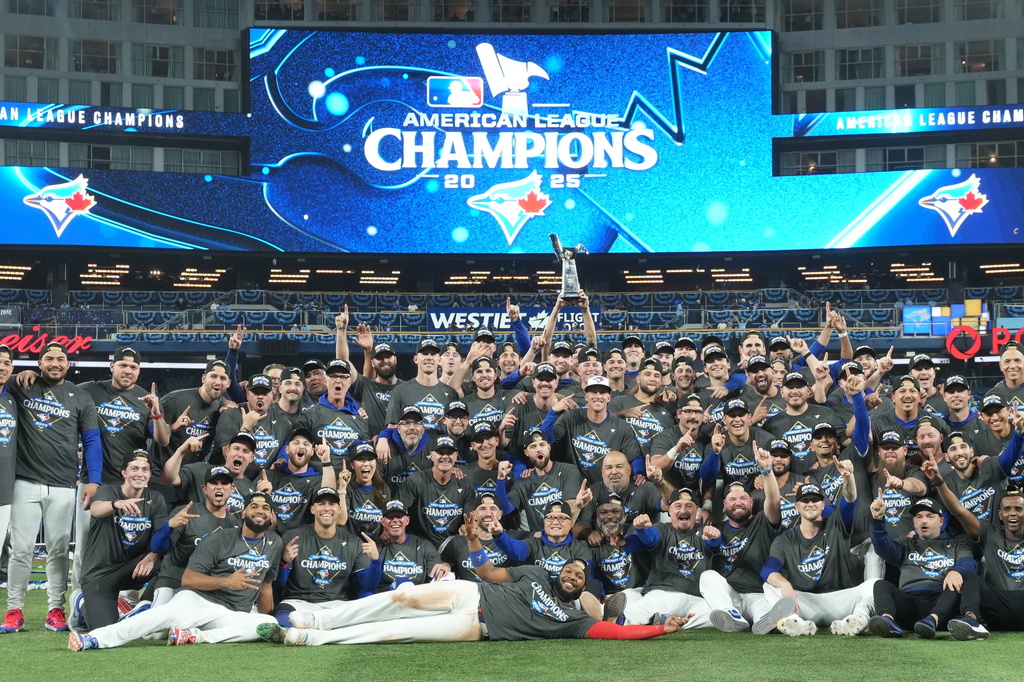 The Toronto Blue Jays pose for a team photo as they celebrate after defeating the Seattle Mariners in MLB American League Championship Series game 7 baseball action in Toronto, Monday, Oct. 20, 2025. (Nathan Denette/The Canadian Press via AP)
