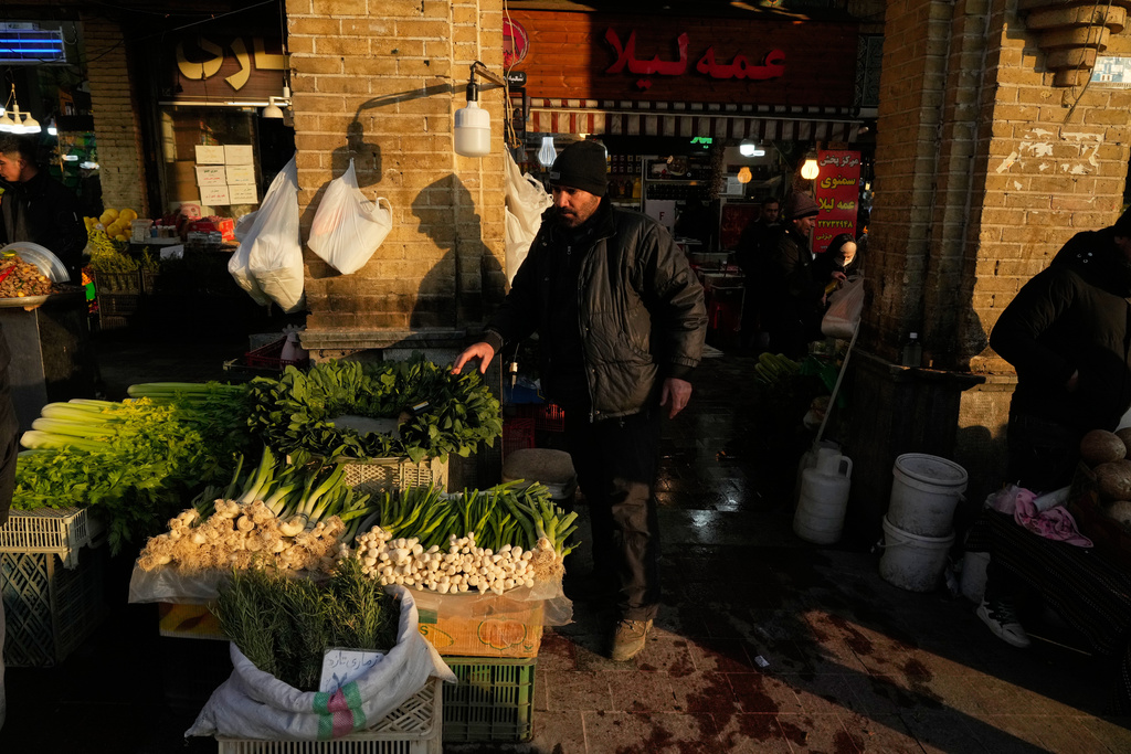 A vendor sells vegetables at the Tajrish bazaar, a market in northern Tehran, Iran, Tuesday, Jan. 27, 2026. (AP Photo/Vahid Salemi)