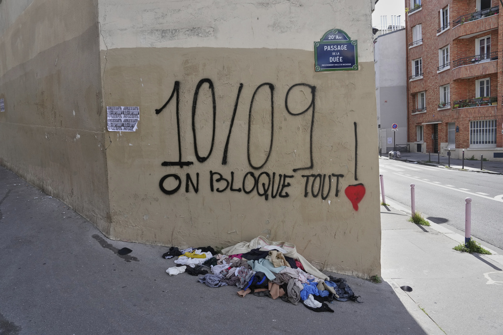 A graffiti reads, "September 10, we shut everything down" in Paris, Tuesday, Sept. 9, 2025, at the eve of a national protest. (AP Photo/Aurelien Morissard)