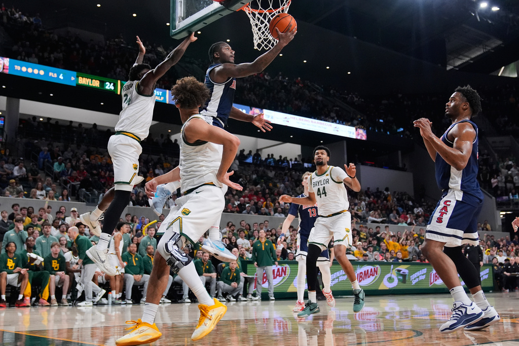 Arizona 's Jaden Bradley shoots after getting past Baylor's Tounde Yessoufou, left, as Caden Powell (44) and others look on in the first half of an NCAA college basketball game in Waco, Texas, Tuesday, Feb. 24, 2026. (AP Photo/Tony Gutierrez)