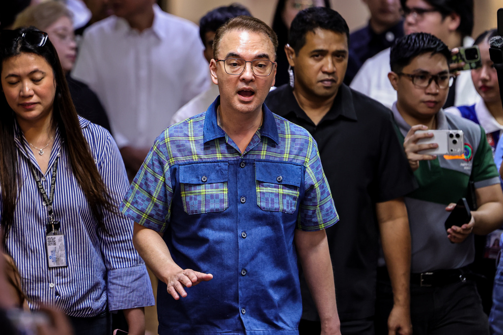 Philippine Senate President Alan Peter Cayetano, center, speaks to the media during a brief press conference at the Senate of the Philippines in Pasay City Thursday, May 14, 2026. (AP Photo/Gerard Carreon)