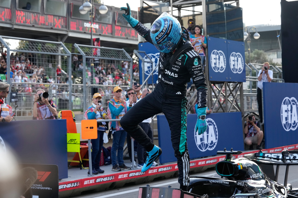Mercedes driver George Russell of Britain celebrates after he clocked the fastest time during the qualifying session for the Azerbaijan F1 Grand Prix, in Baku, Azerbaijan, Friday, Sept. 25, 2026. (AP Photo/Darko Bandic)