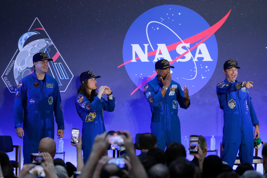 The Artemis II crew, from left, Jeremy Hansen, Christina Koch, Victor Glover and Reid Wiseman acknowledge the crowd as they take the stage during a crew return event Saturday, April 11, 2026, at Ellington Airforce Base in Houston. (AP Photo/Michael Wyke)