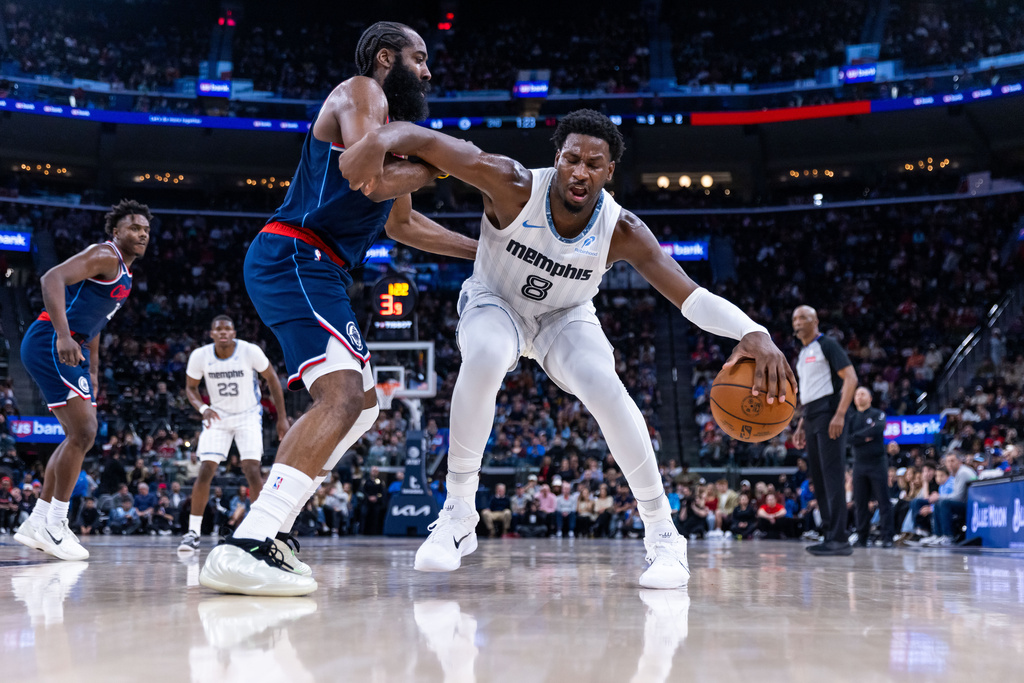 Memphis Grizzlies forward Jaren Jackson Jr. (8) is defended by Los Angeles Clippers guard James Harden, center left, during the first half of an NBA basketball game Monday, Dec. 15, 2025, in Inglewood, Calif. (AP Photo/Ethan Swope)