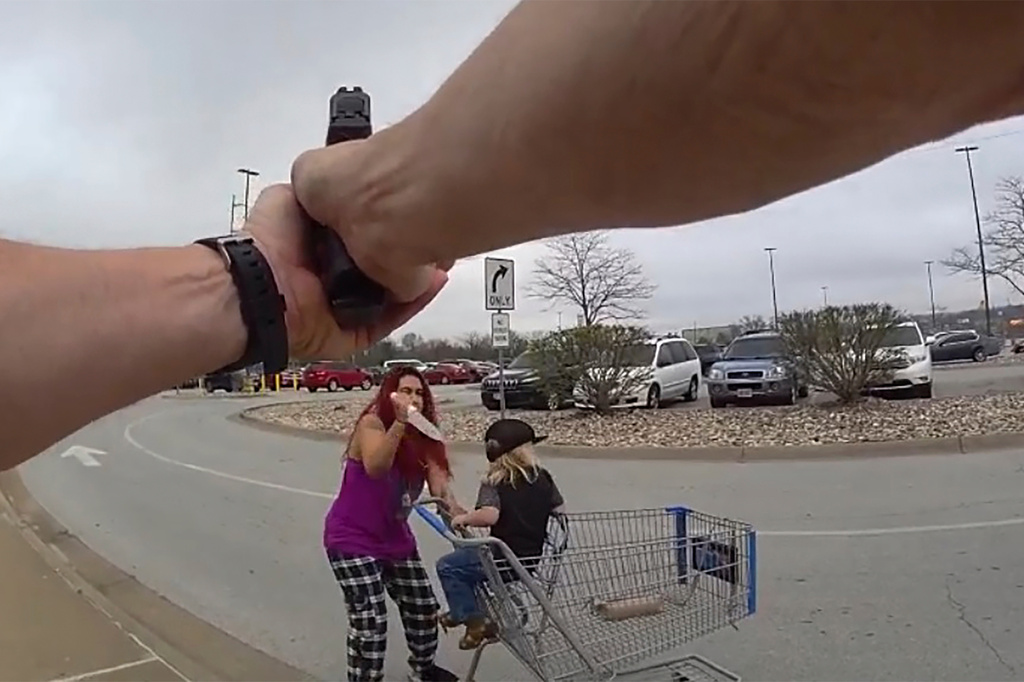 This police body cam still image provided by the Omaha Police Department shows an Omaha police officer responding to a woman they say kidnapped a young boy and slashed him across the face before killing her in Omaha, Neb. on Tuesday April 14, 2026. (Omaha Police Department via AP)