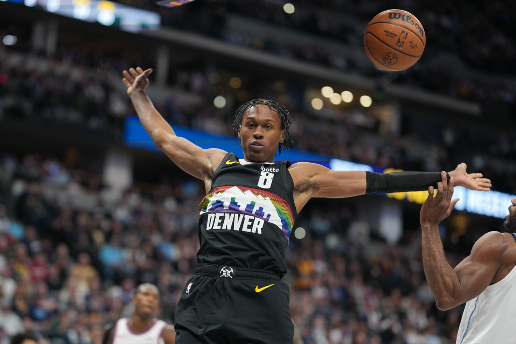 Denver Nuggets guard Peyton Watson (8) reacts after dunking over Los Angeles Clippers forward Kawhi Leonard in the first half of an NBA basketball game Friday, Jan. 30, 2026, in Denver. (AP Photo/David Zalubowski)