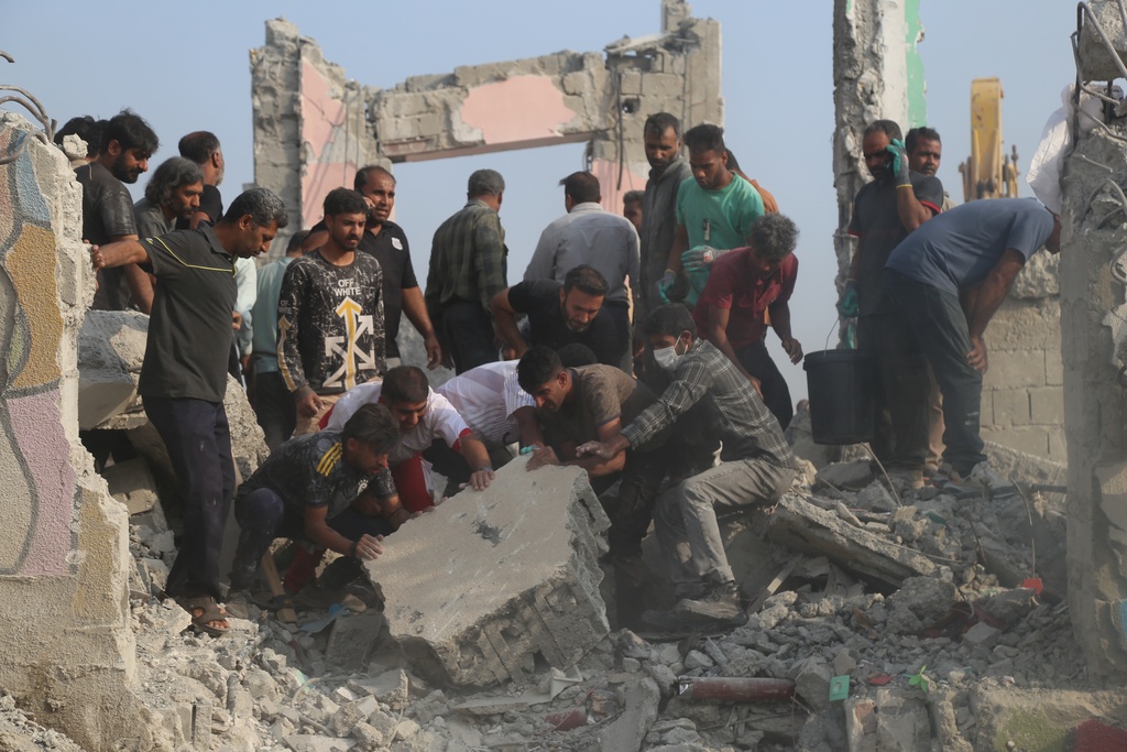 Rescue workers and residents search through the rubble in the aftermath of what Iranian officials said was an Israeli-U.S. strike on a girls' elementary school in Minab, Iran, Saturday, Feb. 28, 2026. (Abbas Zakeri/Mehr News Agency via AP)