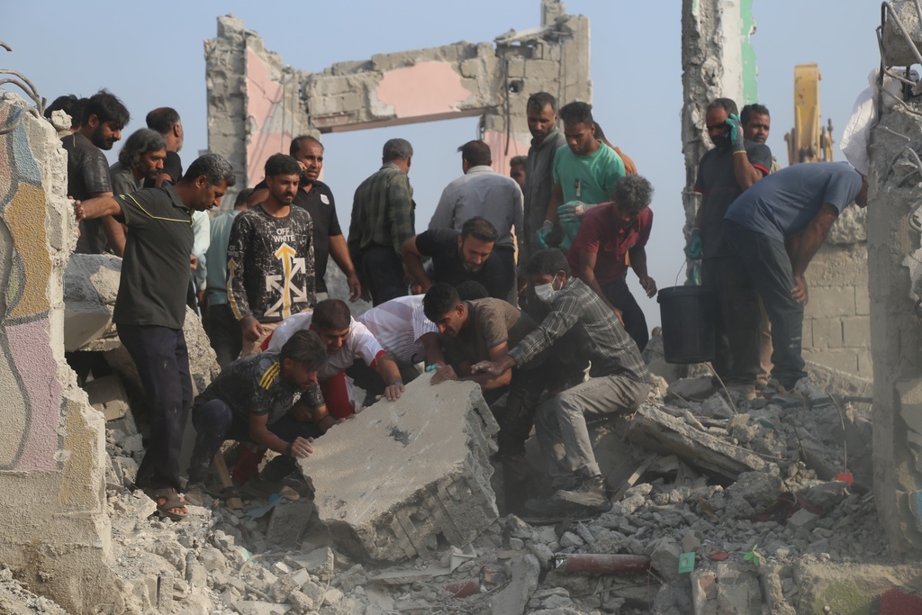 Rescue workers and residents search through the rubble in the aftermath of what Iranian officials said was an Israeli-U.S. strike on a girls' elementary school in Minab, Iran, Saturday, Feb. 28, 2026. (Abbas Zakeri/Mehr News Agency via AP)