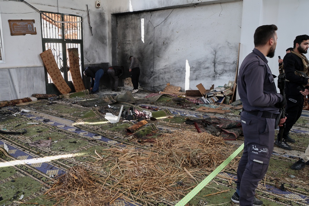 Syrian security forces inspect the damage after an explosion in the Imam Ali bin Abi Talib Mosque in a predominantly Alawite area of the Wadi al-Dhahab neighborhood in Homs, Syria Friday, Dec. 26, 2025.(AP Photo)