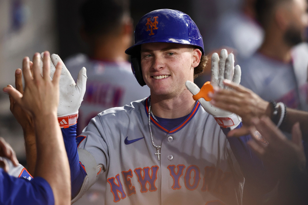 New York Mets right fielder Carson Benge celebrates with teammates in the dugout after hitting a home run during the fifth inning of a baseball game against the Chicago White Sox in Chicago, Saturday, Aug. 22, 2026. (AP Photo/Jessie Alcheh)