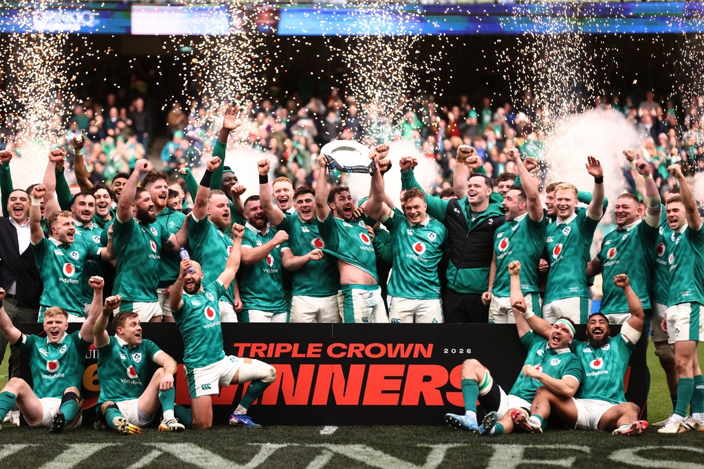 Ireland's team celebrates after winning the "triple crown" trophy following the Six Nations rugby union match against Scotland, in Dublin, Saturday, March 14, 2026. (AP Photo/Peter Morrison)