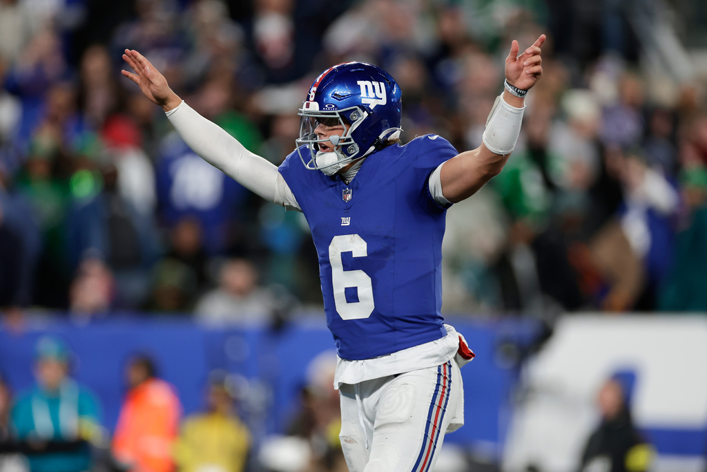 New York Giants' Jaxson Dart reacts after a touchdown during the second half of an NFL football game against the Philadelphia Eagles Thursday, Oct. 9, 2025, in East Rutherford, N.J. (AP Photo/Adam Hunger)