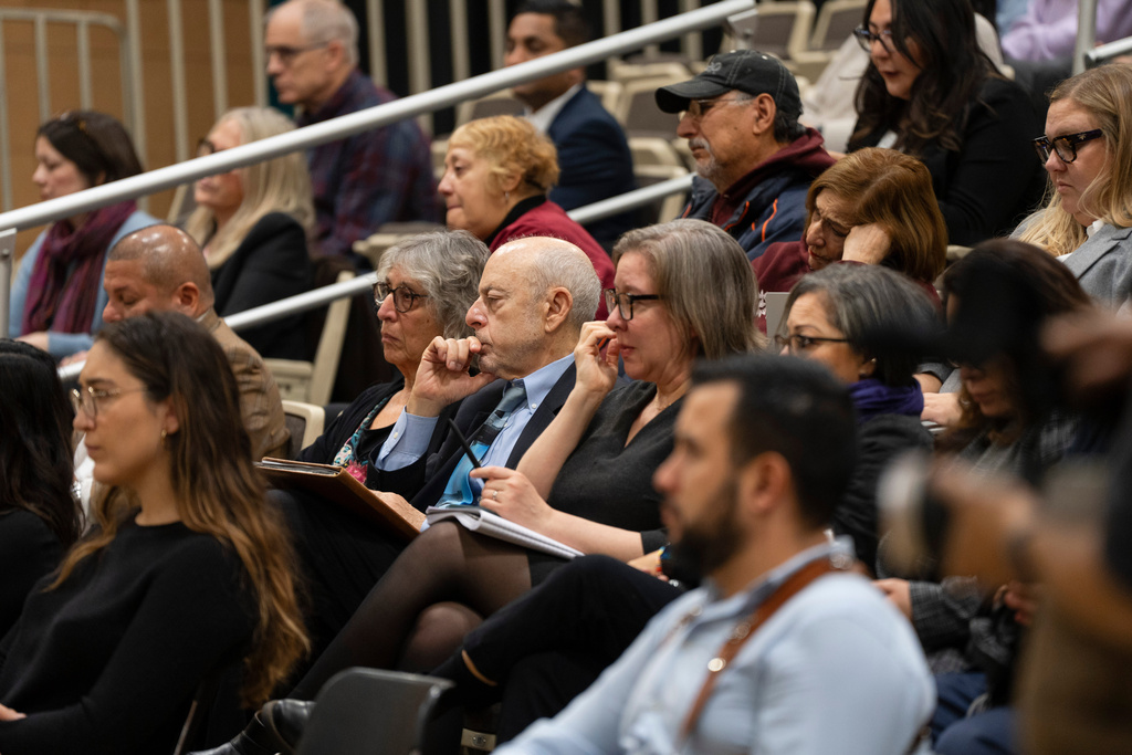 Attendees listen during the Illinois Accountability Commission's first hearing at Arturo Velasquez Institute at Richard J. Daley College in the Lower West Side of Chicago, Thursday, Dec. 18, 2025. (Chicago Sun-Times via AP)
