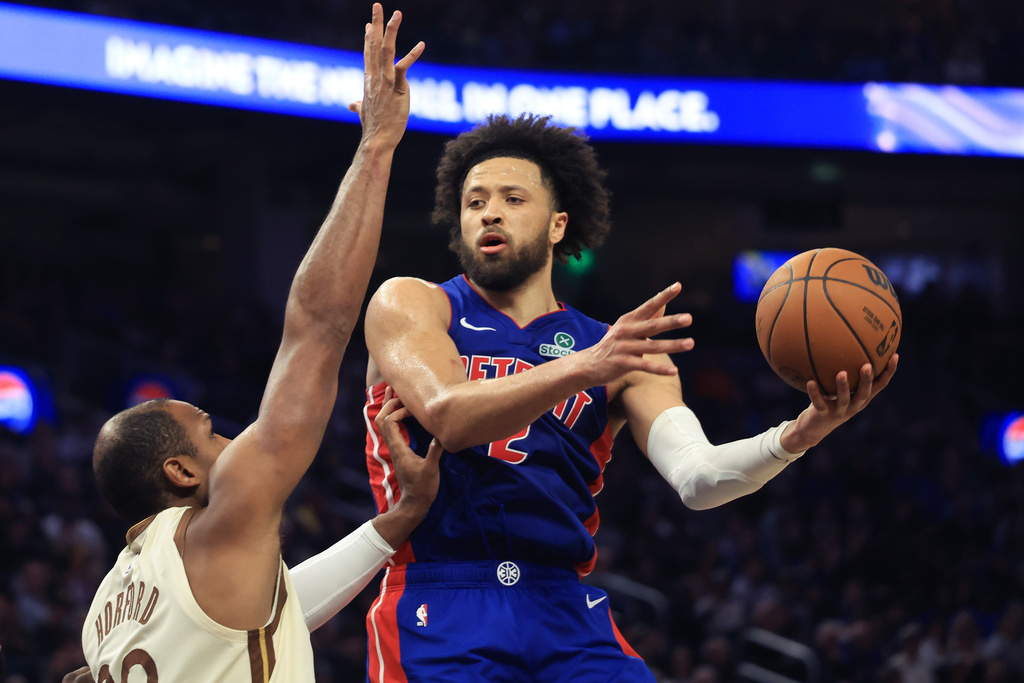 Detroit Pistons guard Cade Cunningham, right, looks to pass the ball against Golden State Warriors center Al Horford, left, during the first half of an NBA basketball game in San Francisco, Friday, Jan. 30, 2026. (AP Photo/Jed Jacobsohn)