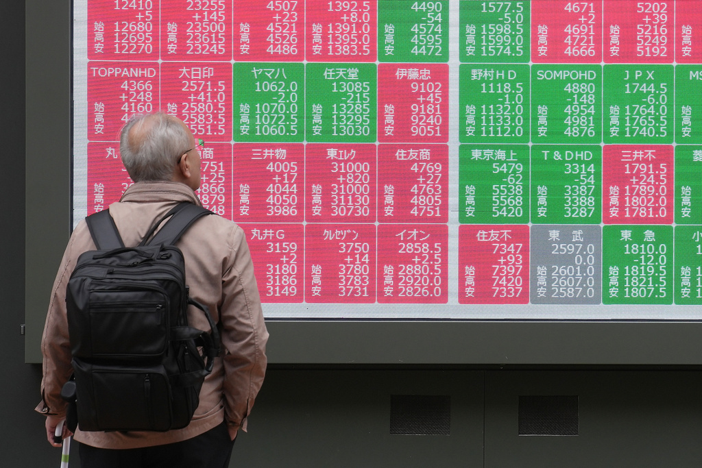 A person looks at an electronic stock board showing Japan's Nikkei index at a securities firm Tuesday, Nov. 25, 2025, in Tokyo. (AP Photo/Eugene Hoshiko)