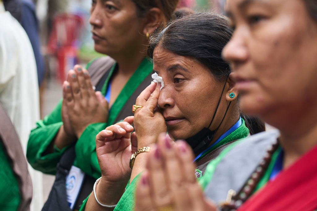 A Tibetan woman sobs while she offers prayers during the 91st birthday celebration of spiritual leader the Dalai Lama in Kathmandu, Nepal, Monday, July 6, 2026. (AP Photo/Niranjan Shrestha)