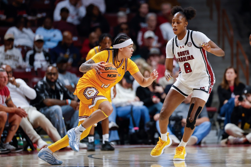 Winthrop guard Mya Pierfax, left, drives against South Carolina forward Joyce Edwards during the first half of an NCAA college basketball game in Columbia, S.C., Wednesday, Nov. 19, 2025. (AP Photo/Nell Redmond)