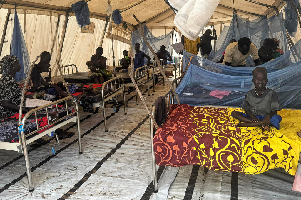 Patients sit inside a medical clinic where children with malnutrition are treated, in Chuil, Nyirol County, Jonglei State, South Sudan, Friday, April 10, 2026. (AP Photo/Joseph Falzetta)