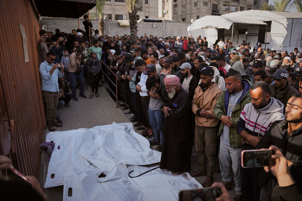 Mourners pray over the bodies Palestinians killed in an Israeli army strike, during their funeral at Nasser Hospital in Khan Younis, Gaza Strip Thursday, Nov. 20, 2025. (AP Photo/Abdel Kareem Hana)