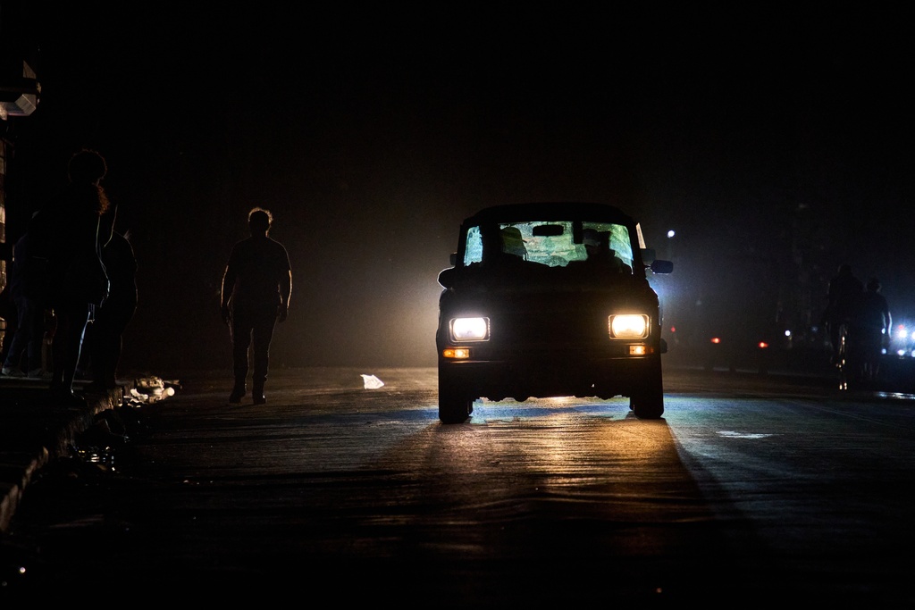 A vehicle drives down a street during a blackout in Havana, Wednesday, March 4, 2026. (AP Photo/Ramon Espinosa)