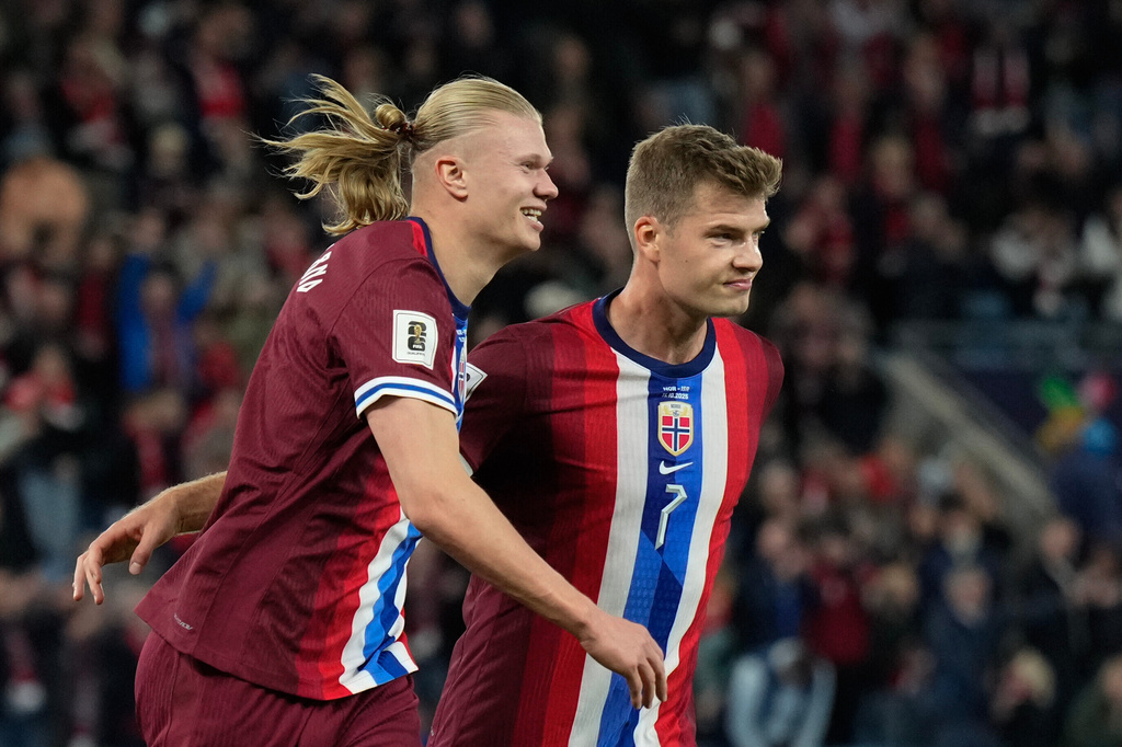 Norway's Erling Haaland, left, celebrates after scoring his third goal during the World Cup qualifying soccer match between Norway and Israel in Oslo, Saturday, Oct. 11, 2025. (Fredrik Varfjell/NTB Scanpix via AP)