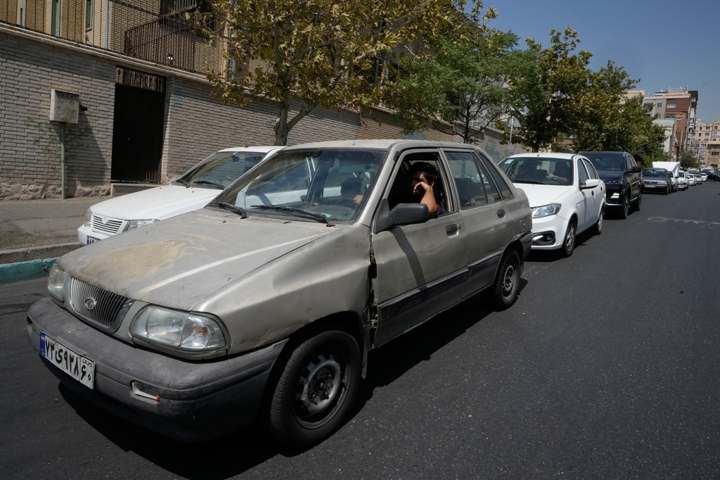 Cars line up outside a gas station in Tehran, Iran, Tuesday, Aug. 25, 2026. (AP Photo/Vahid Salemi)